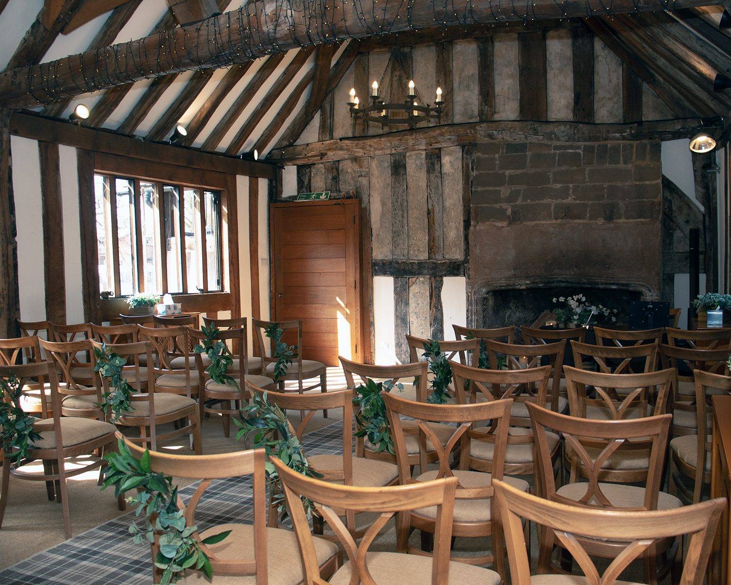 The ceremony room dressed with blossom and candles
