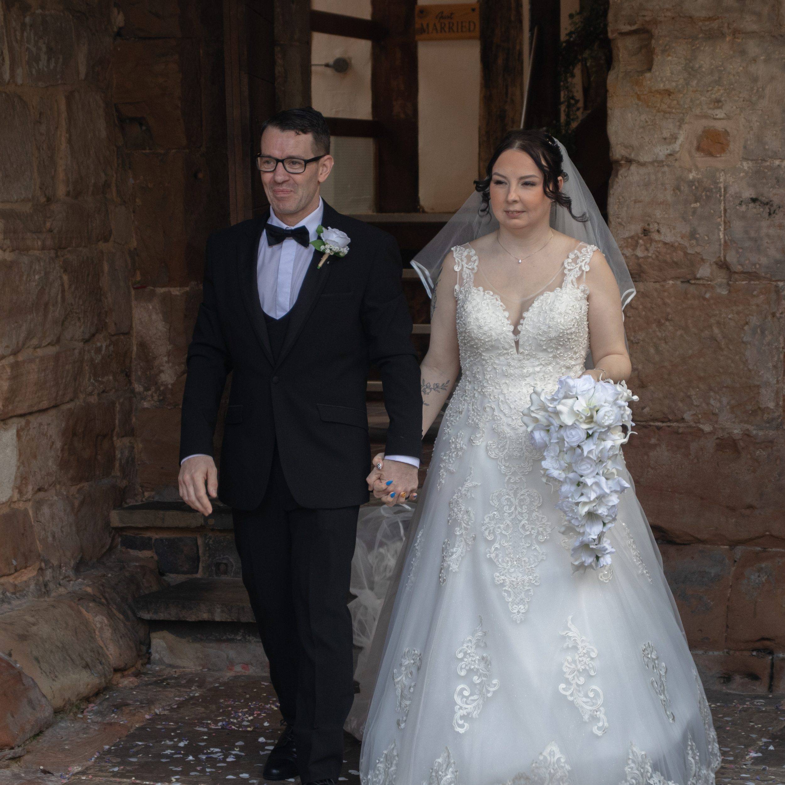 Checka and Matthew walking out hand in hand after their ceremony