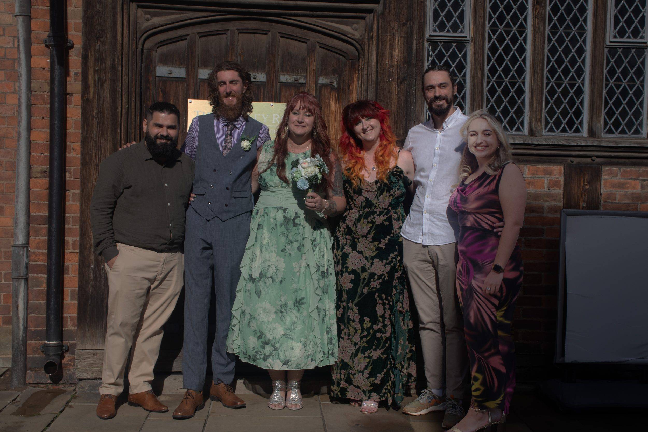 The wedding party outside the timber framed venue