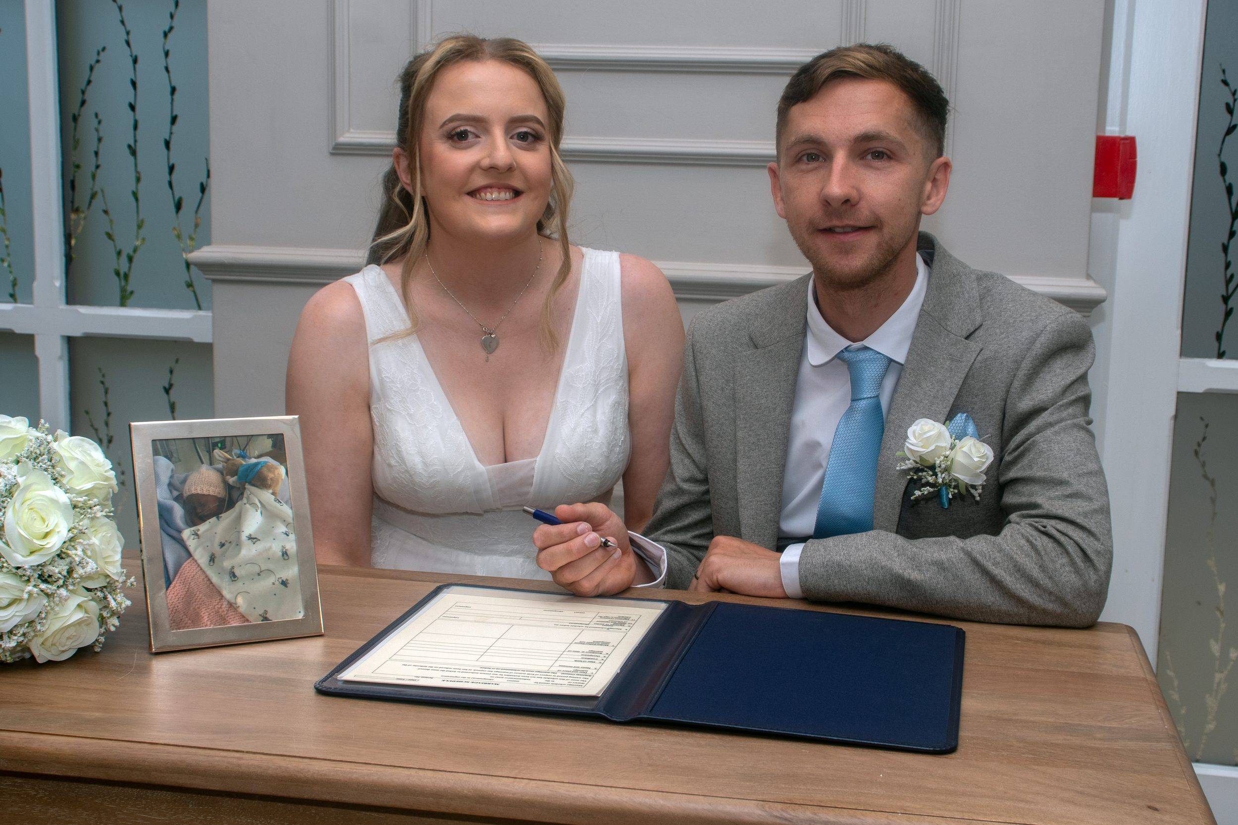 Luke and Alex signing the register together