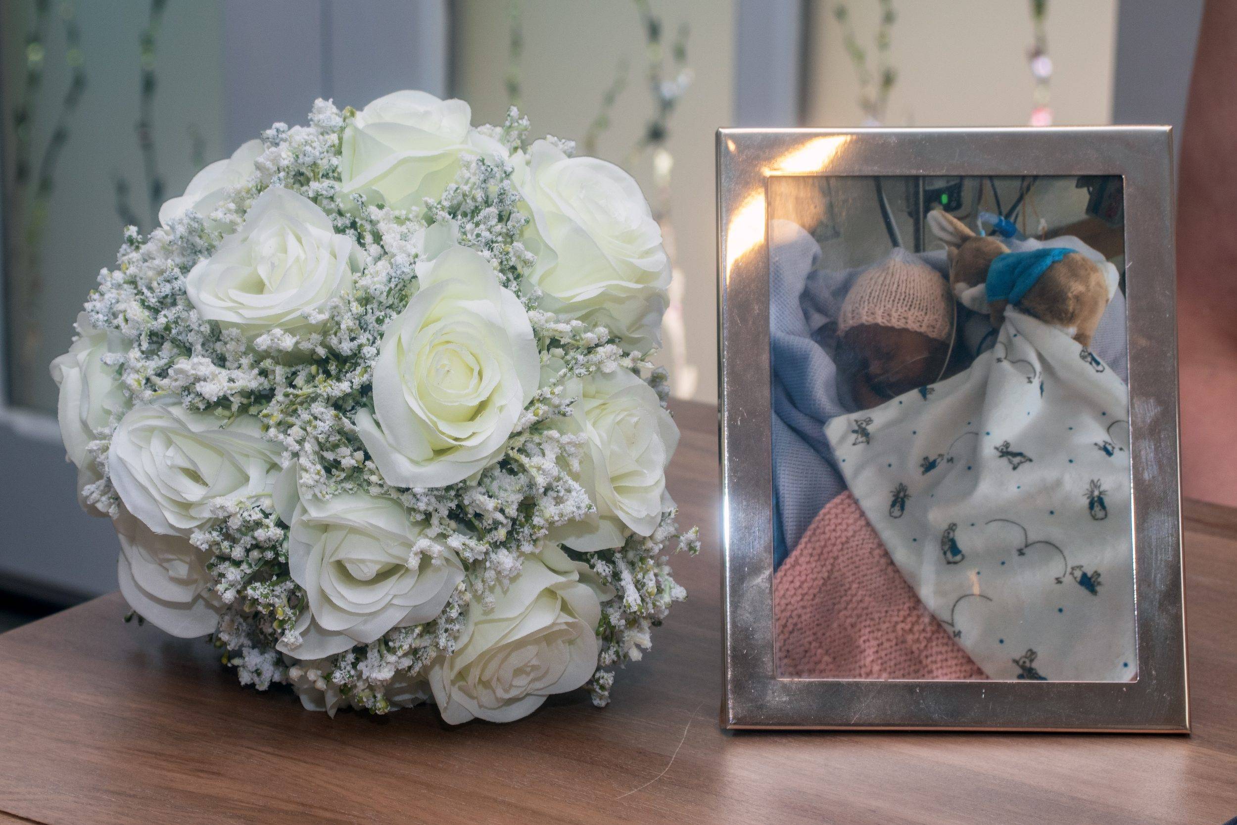 The bouquet beside a framed family photograph