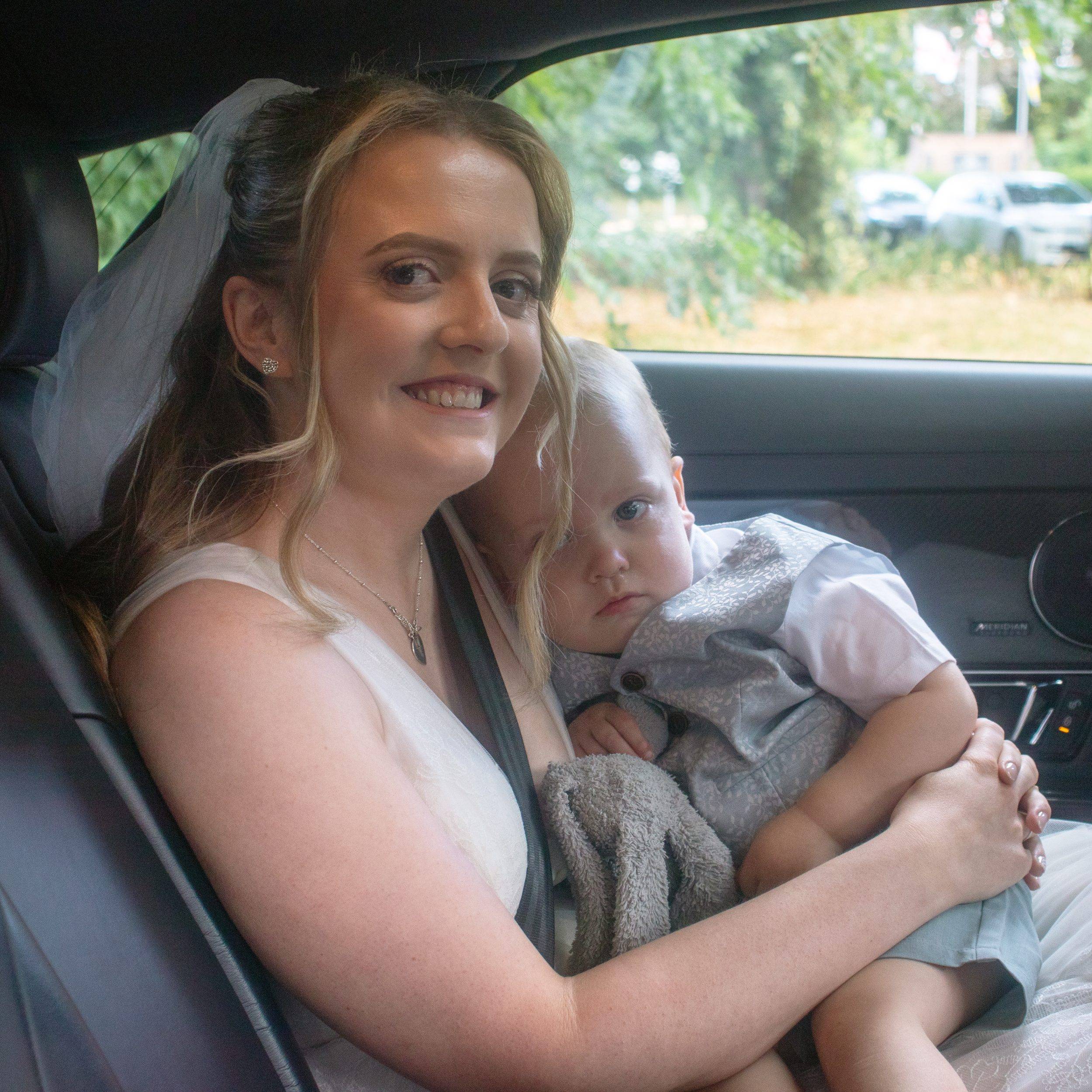 Alex in the car with one of the children