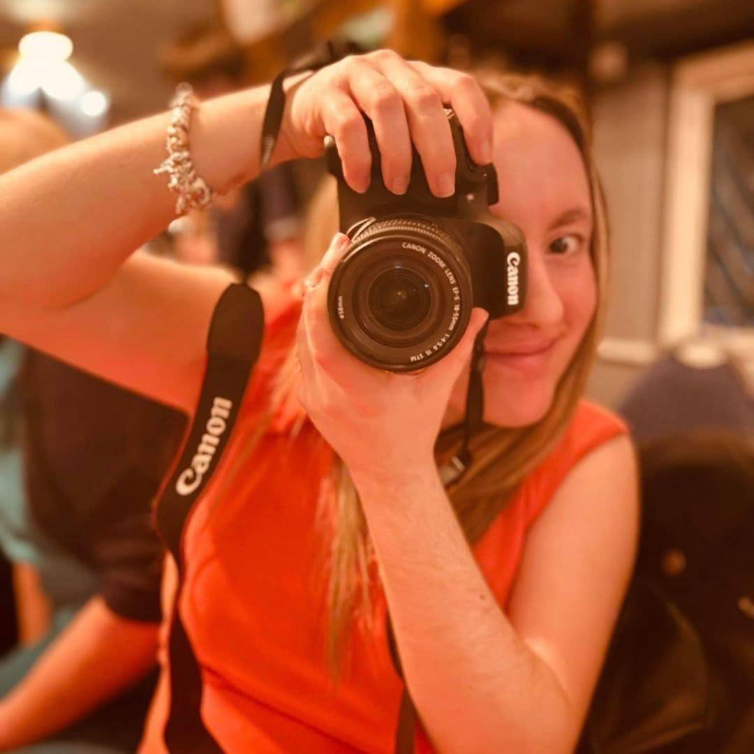 Amy Bloodworth photographing a wedding with her camera