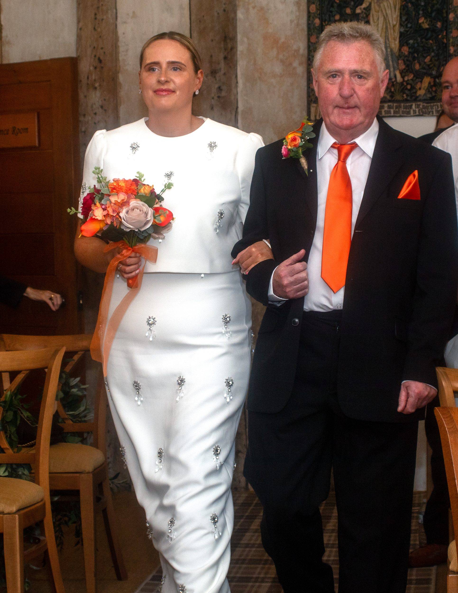Rhiann walking down the aisle with her father