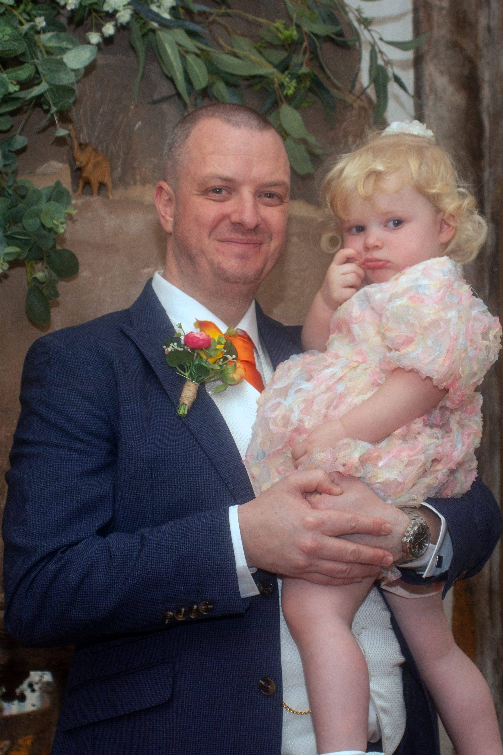 Rob holding his daughter after the ceremony