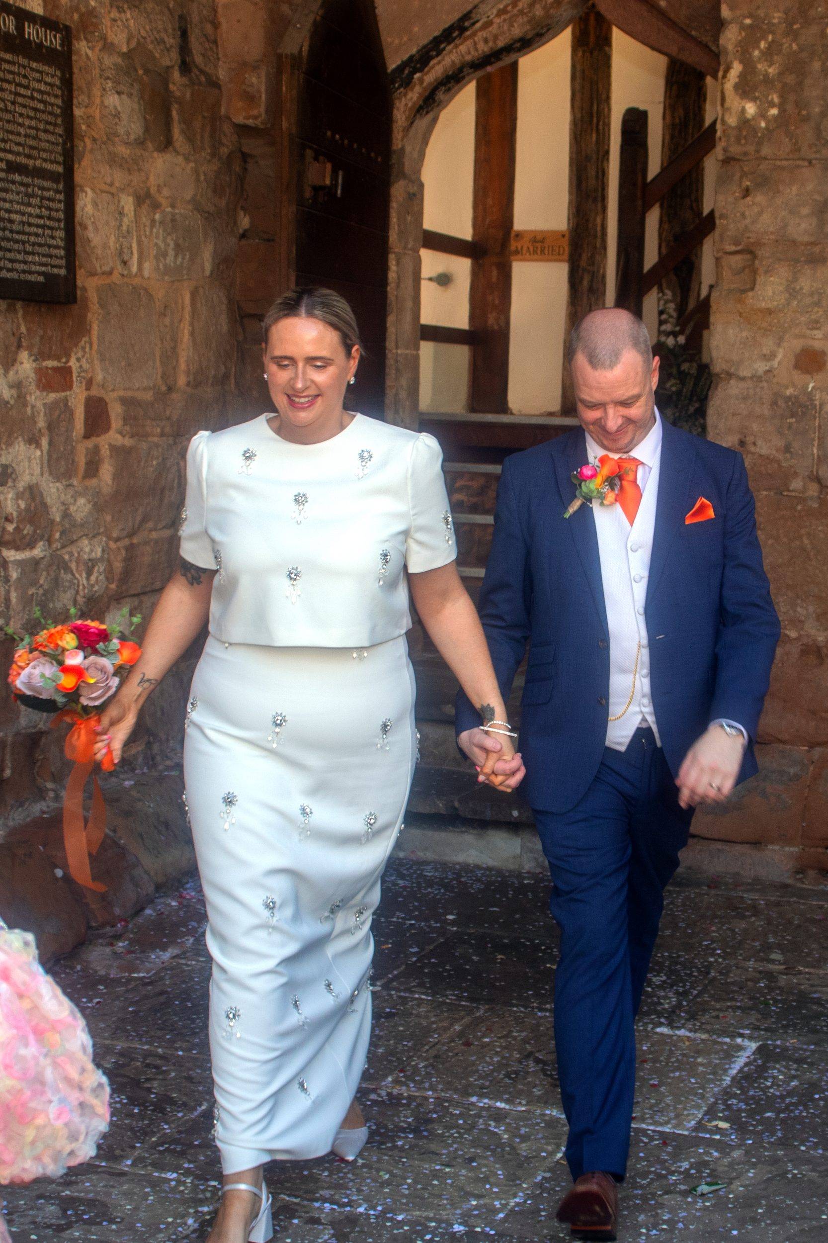 Rhiann and Rob walking out of the ceremony room together
