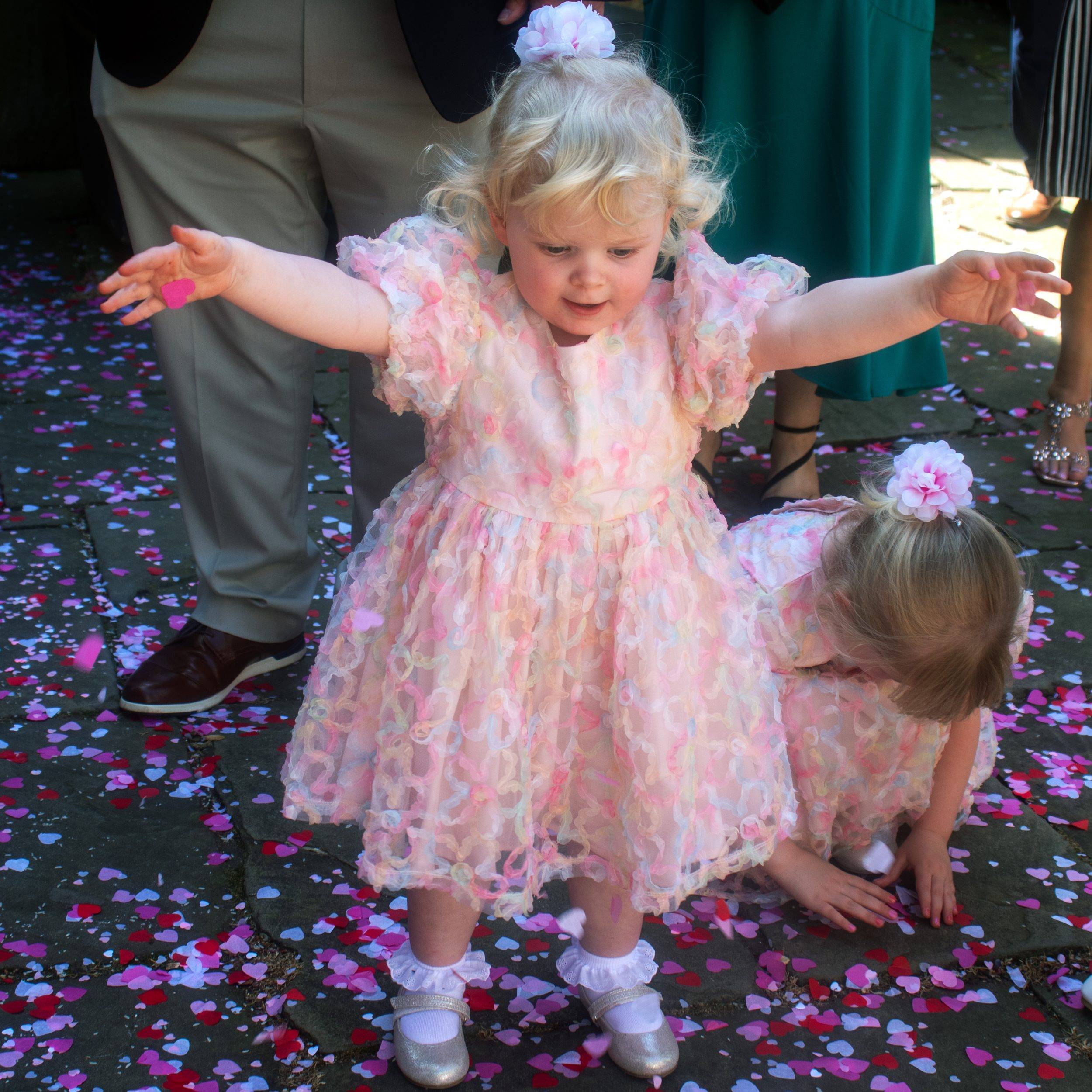 Their youngest daughter in the confetti outside