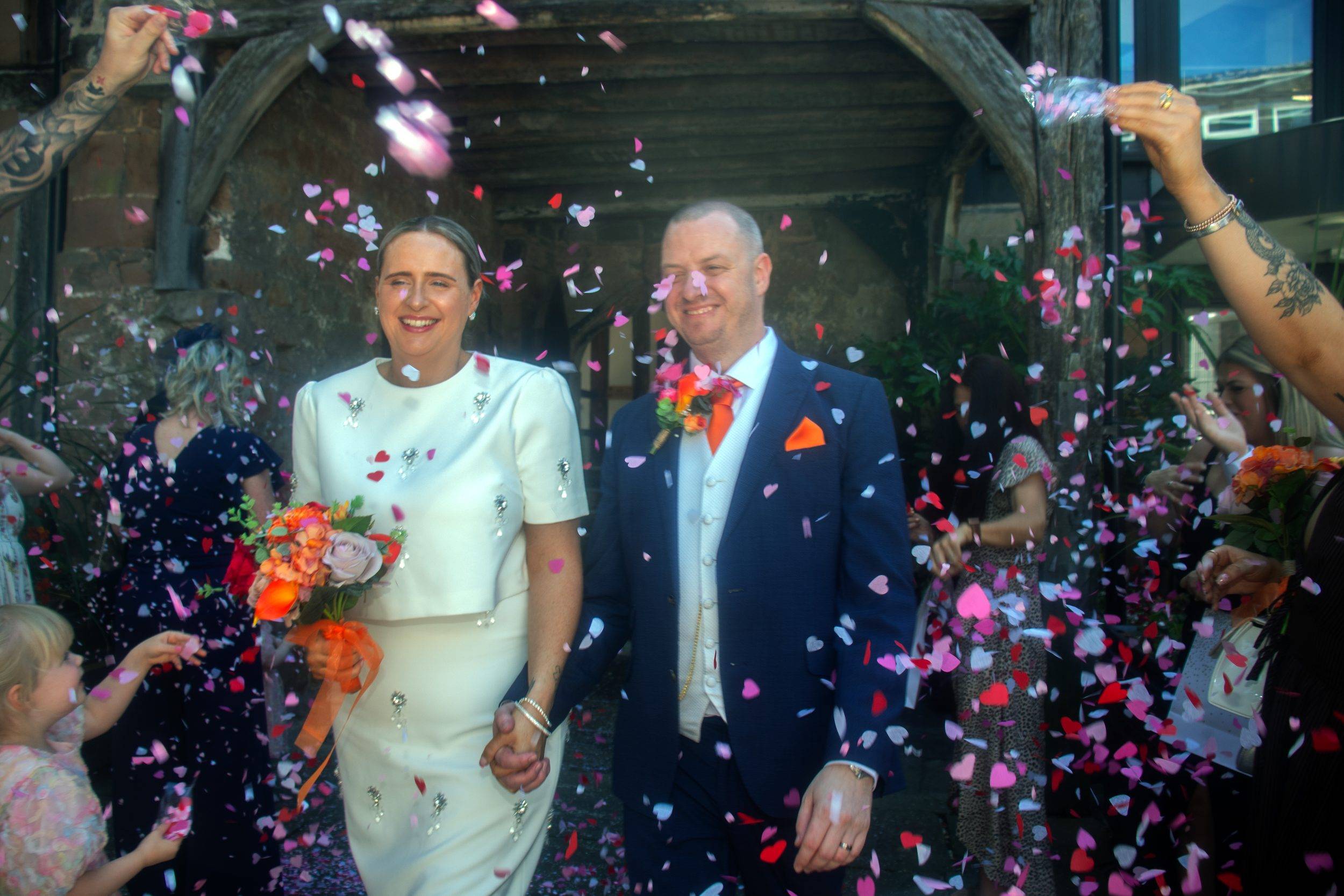 Rhiann and Rob showered in confetti as they leave the ceremony