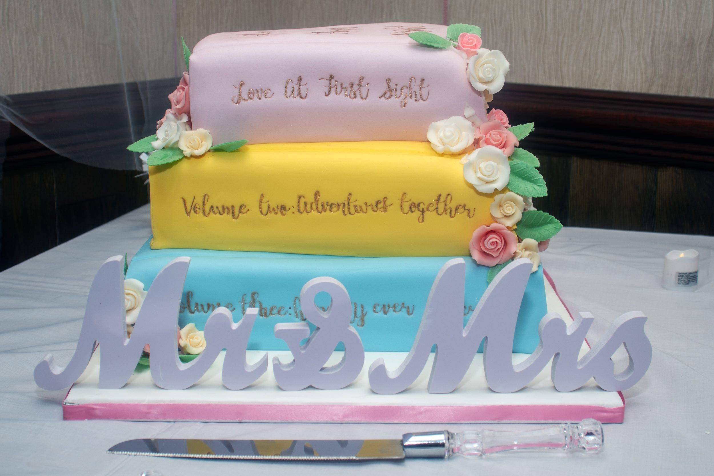 The wedding cake made to look like a stack of books