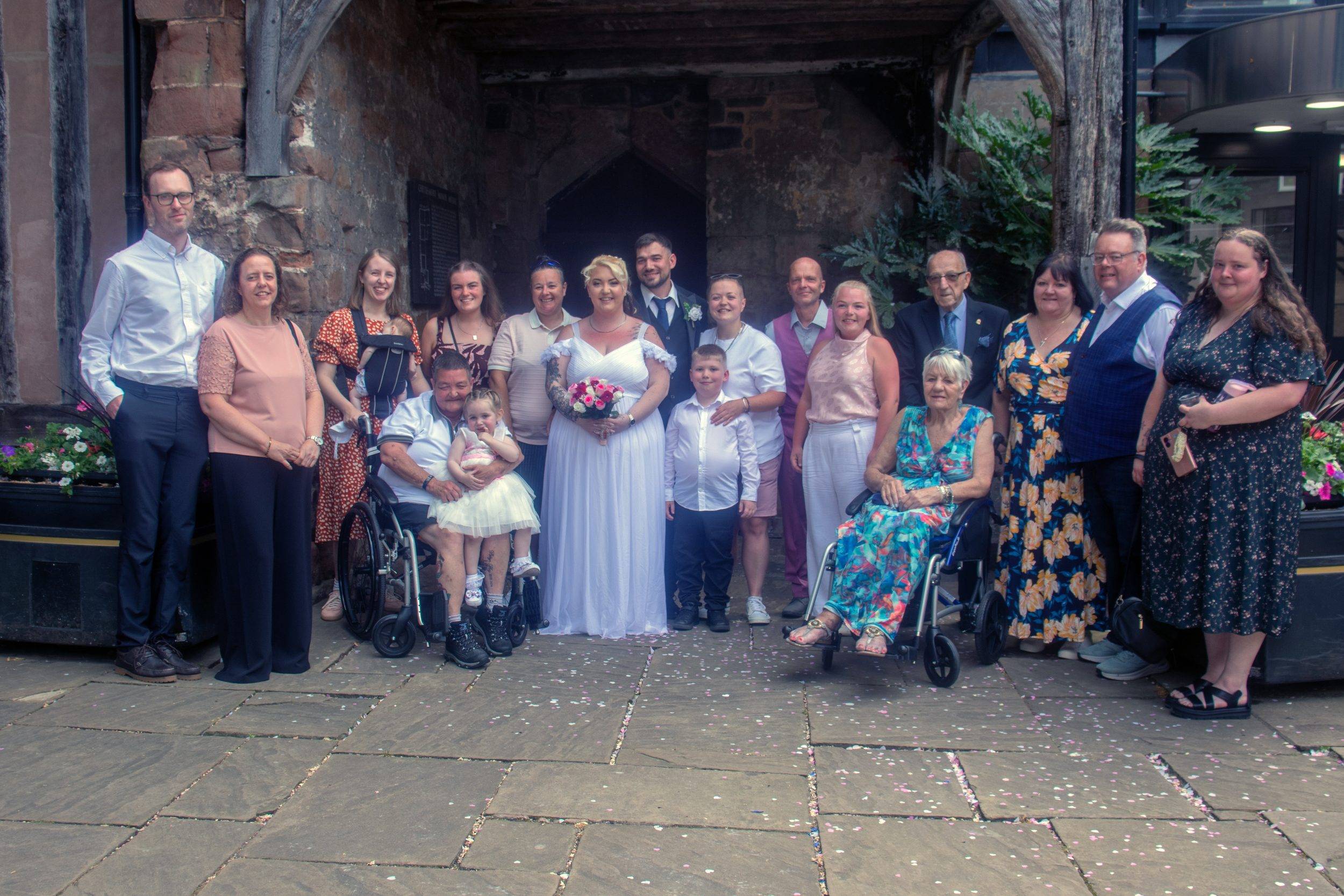 The whole group photographed together outside the venue
